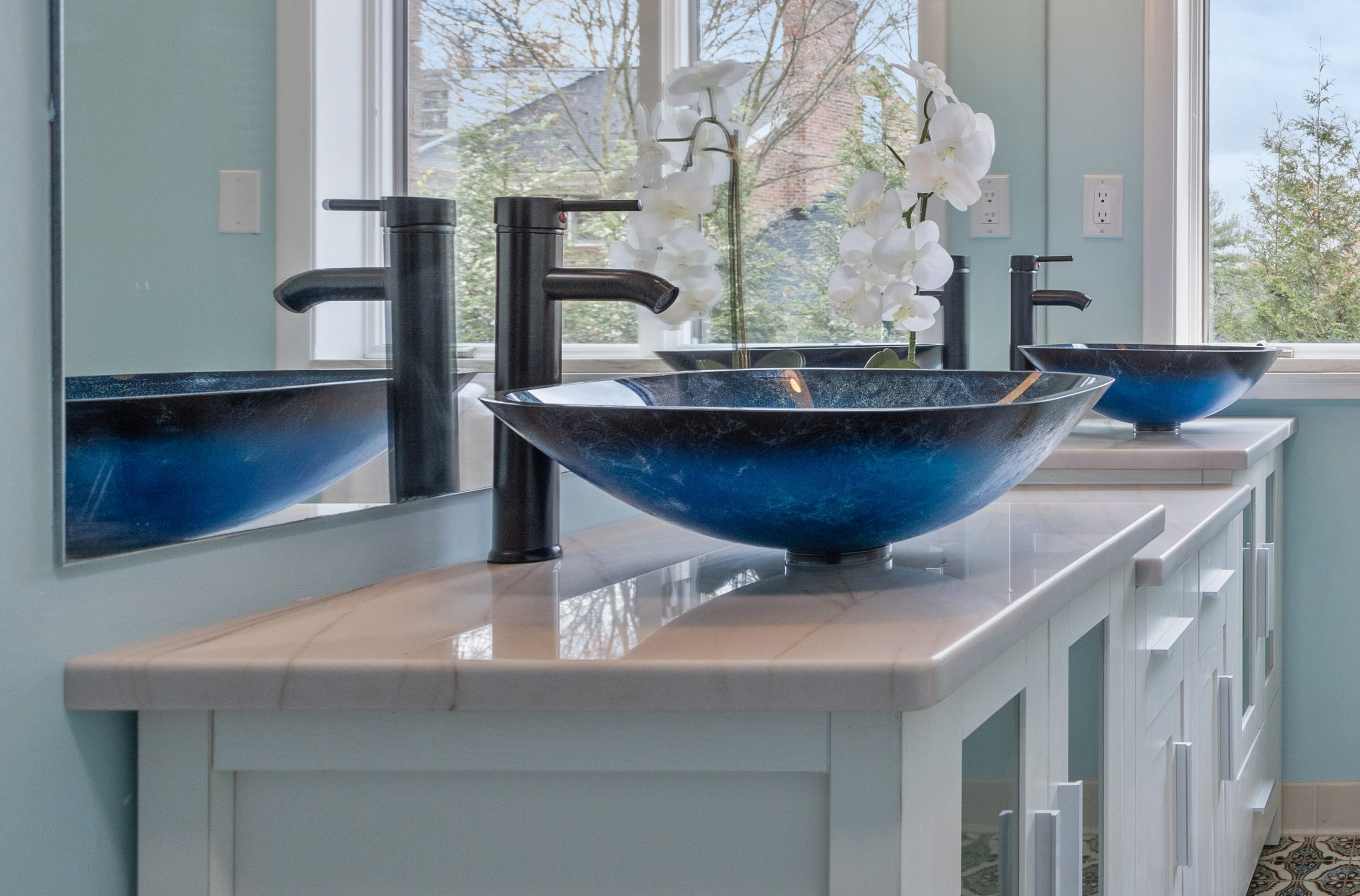 Sky-Gold quartzite countertop with blue vessel sink